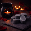 After Dark wax melts arranged beside a black wax burner in a moody, romantic setting with soft candlelight.