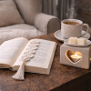 A calming scene featuring a crochet bookmark resting on a closed book beside a handmade crochet lavender pouch, styled in soft neutral tones to evoke rest and relaxation.